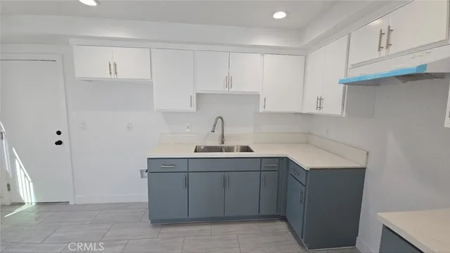 a kitchen with a sink cabinets and appliances