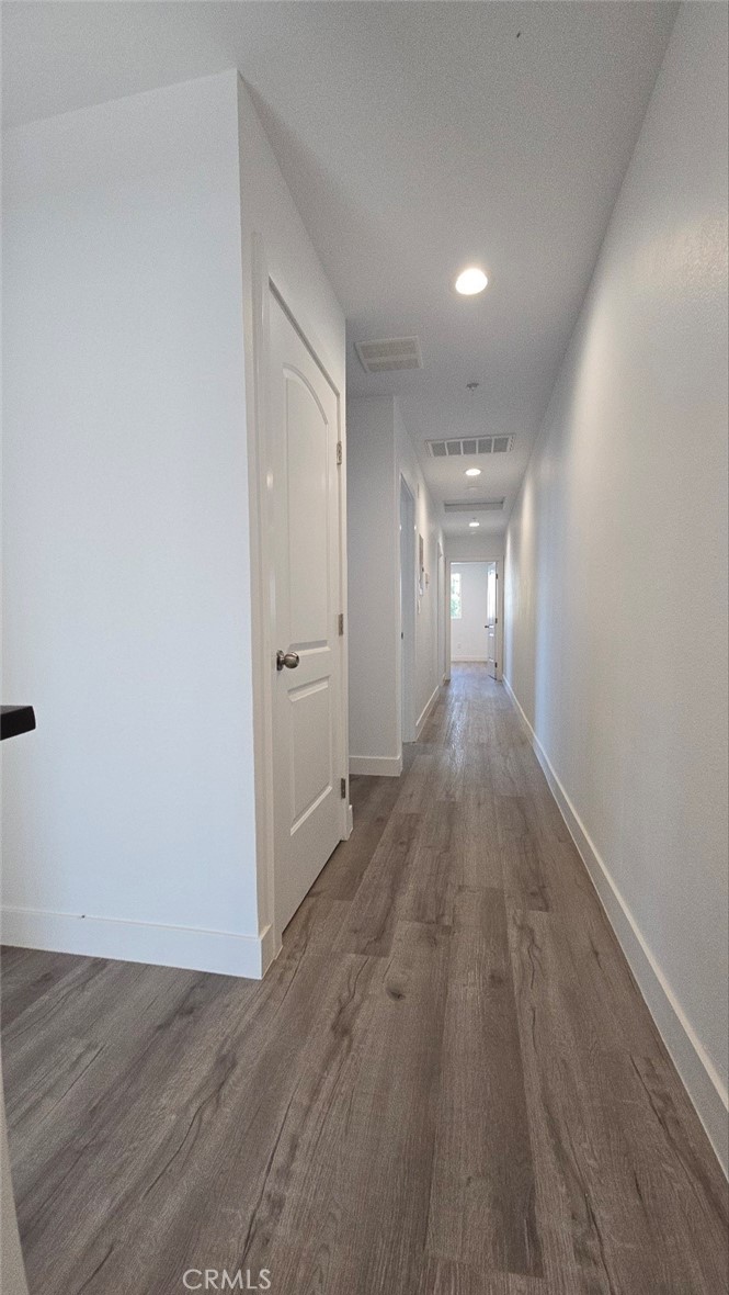 10415 South Avalon Boulevard Los Angeles, CA 90003 - Photo 12 of 40 a view of a hallway with wooden floor
