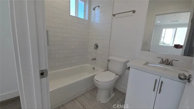 a utility room with a sink and a toilet