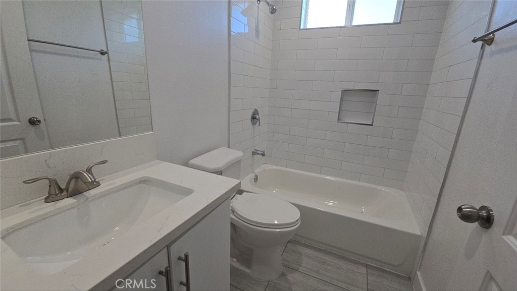 10415 South Avalon Boulevard Los Angeles, CA 90003 - Photo 19 of 40 a bathroom with a sink a toilet and shower