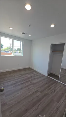 a view of an empty room with a kitchen