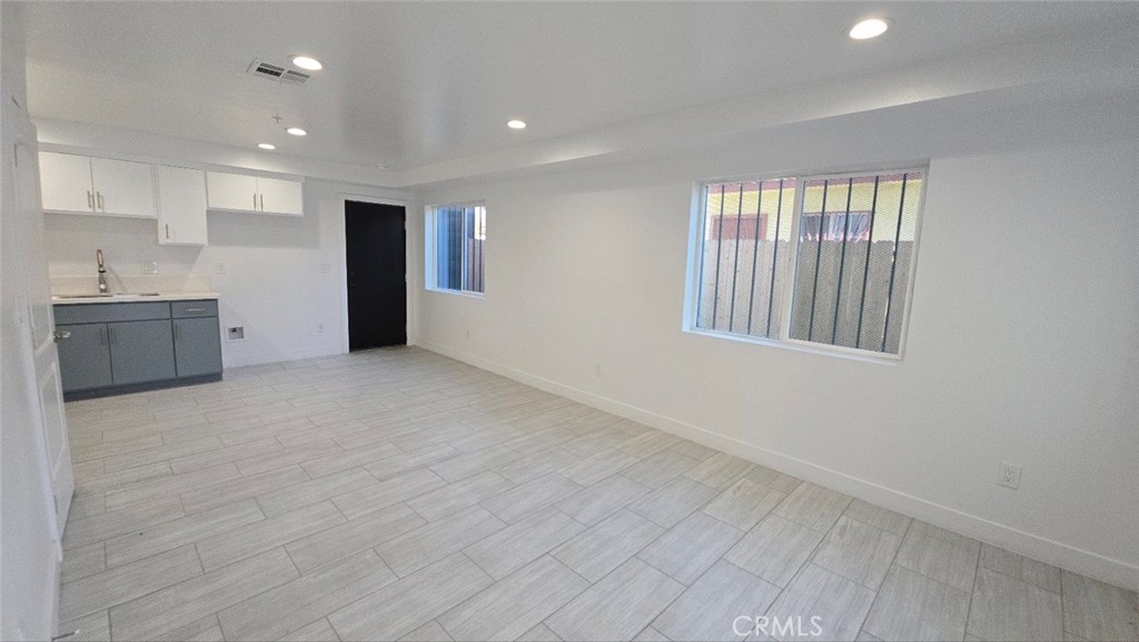 10415 South Avalon Boulevard Los Angeles, CA 90003 - Photo 21 of 40 a view of an empty room with a kitchen