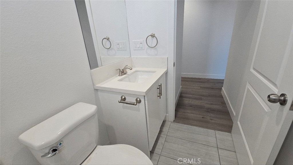 10415 South Avalon Boulevard Los Angeles, CA 90003 - Photo 25 of 40 a bathroom with a toilet sink and mirror