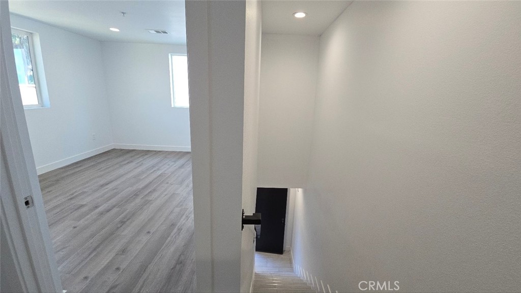 10415 South Avalon Boulevard Los Angeles, CA 90003 - Photo 34 of 40 a view of a hallway with wooden floor