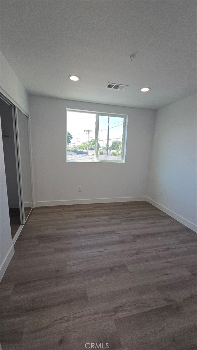 10415 South Avalon Boulevard Los Angeles, CA 90003 - Photo 37 of 40 an empty room with wooden floor and windows