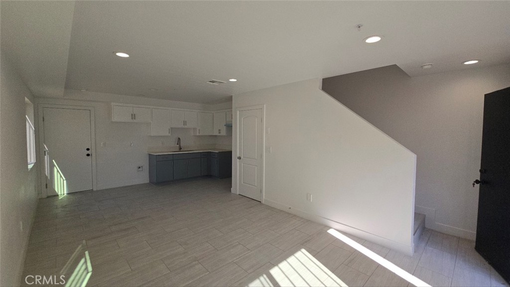 10415 South Avalon Boulevard Los Angeles, CA 90003 - Photo 5 of 40 a view of empty room with kitchen and window