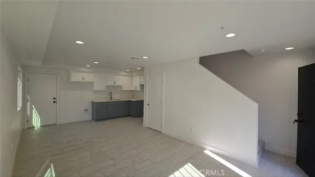 a kitchen with a sink a stove and cabinets