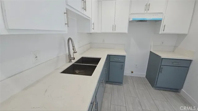 a kitchen with a sink cabinets and appliances