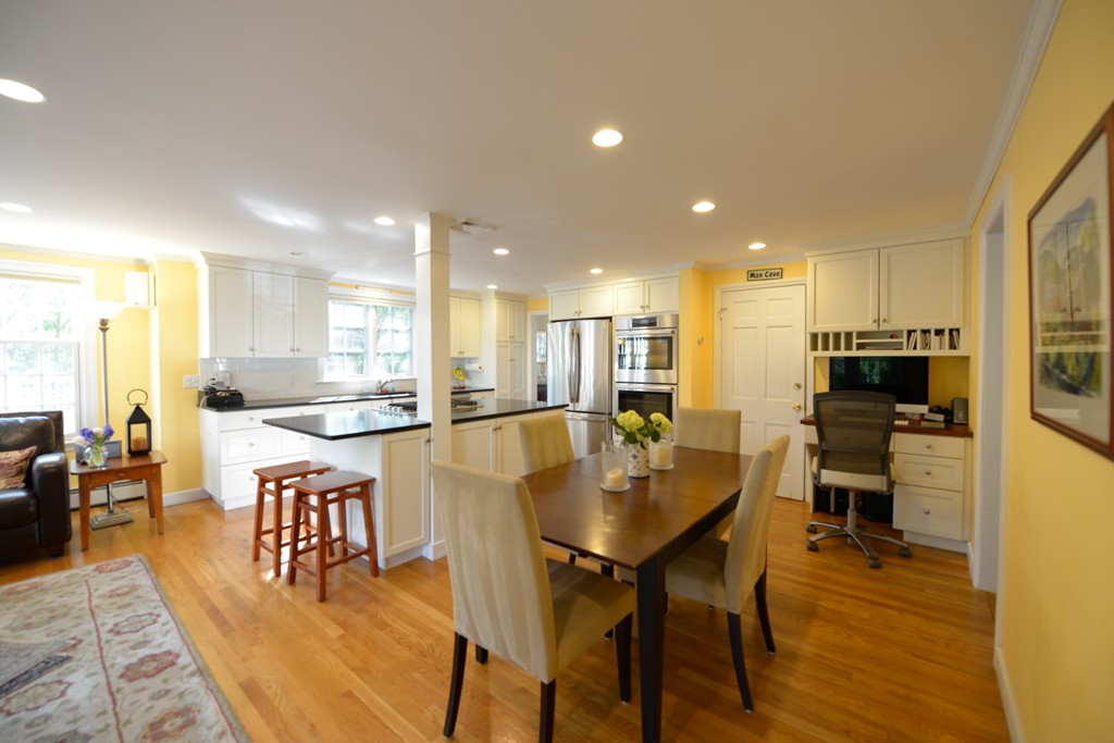 5 Ingraham Road Wellesley, MA 02482 - Photo 4 of 11 a dining room with stainless steel appliances kitchen island granite countertop a table and chairs