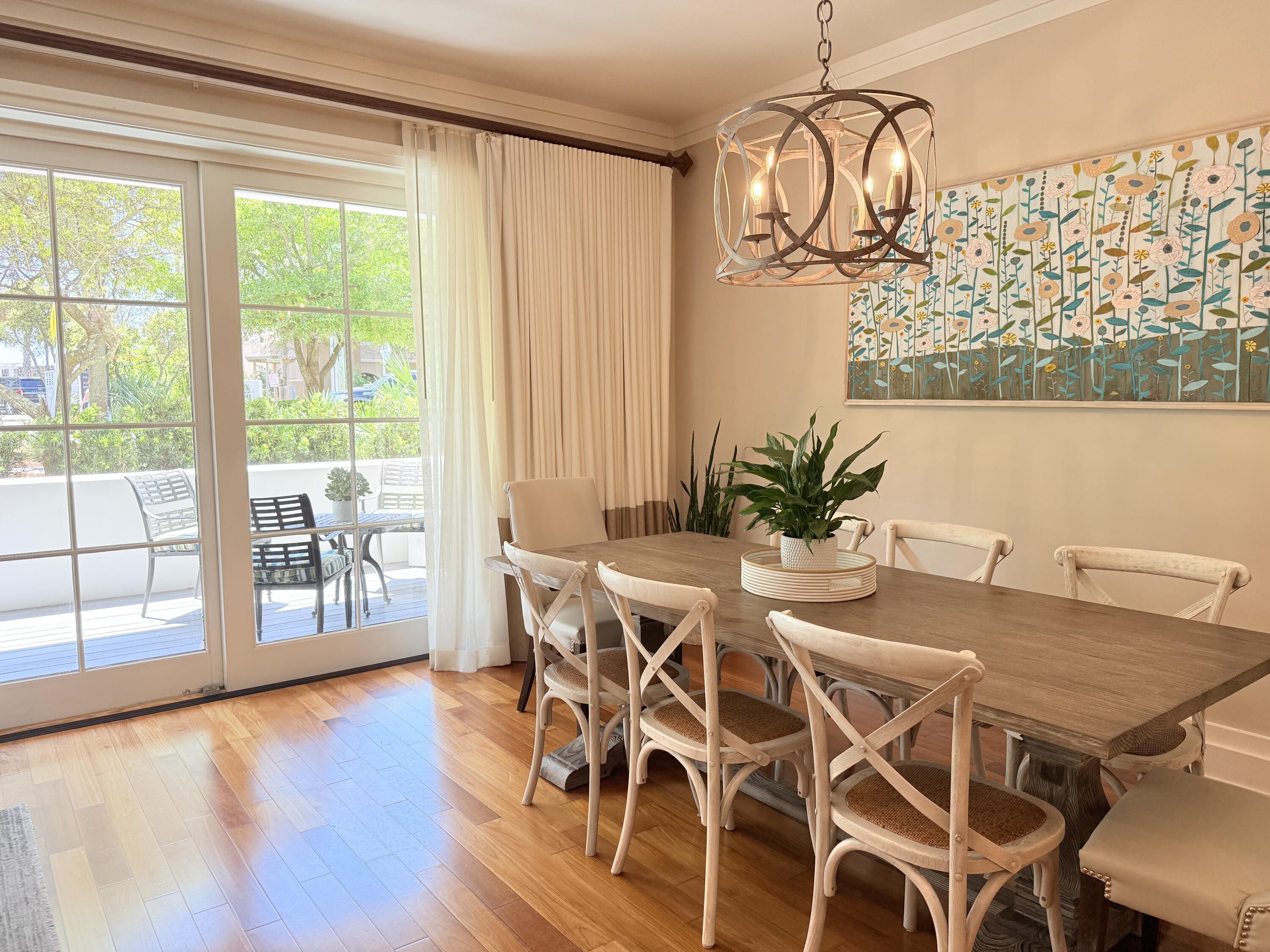 32461 East County Highway 30A, Unit 104 Inlet Beach, FL 32461 - Photo 16 of 97 a view of a dining room with furniture window and wooden floor