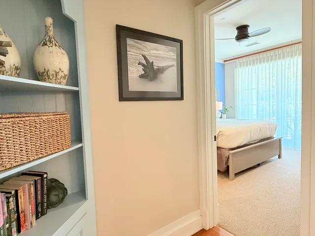 a bedroom with a bed and a dresser next to a window