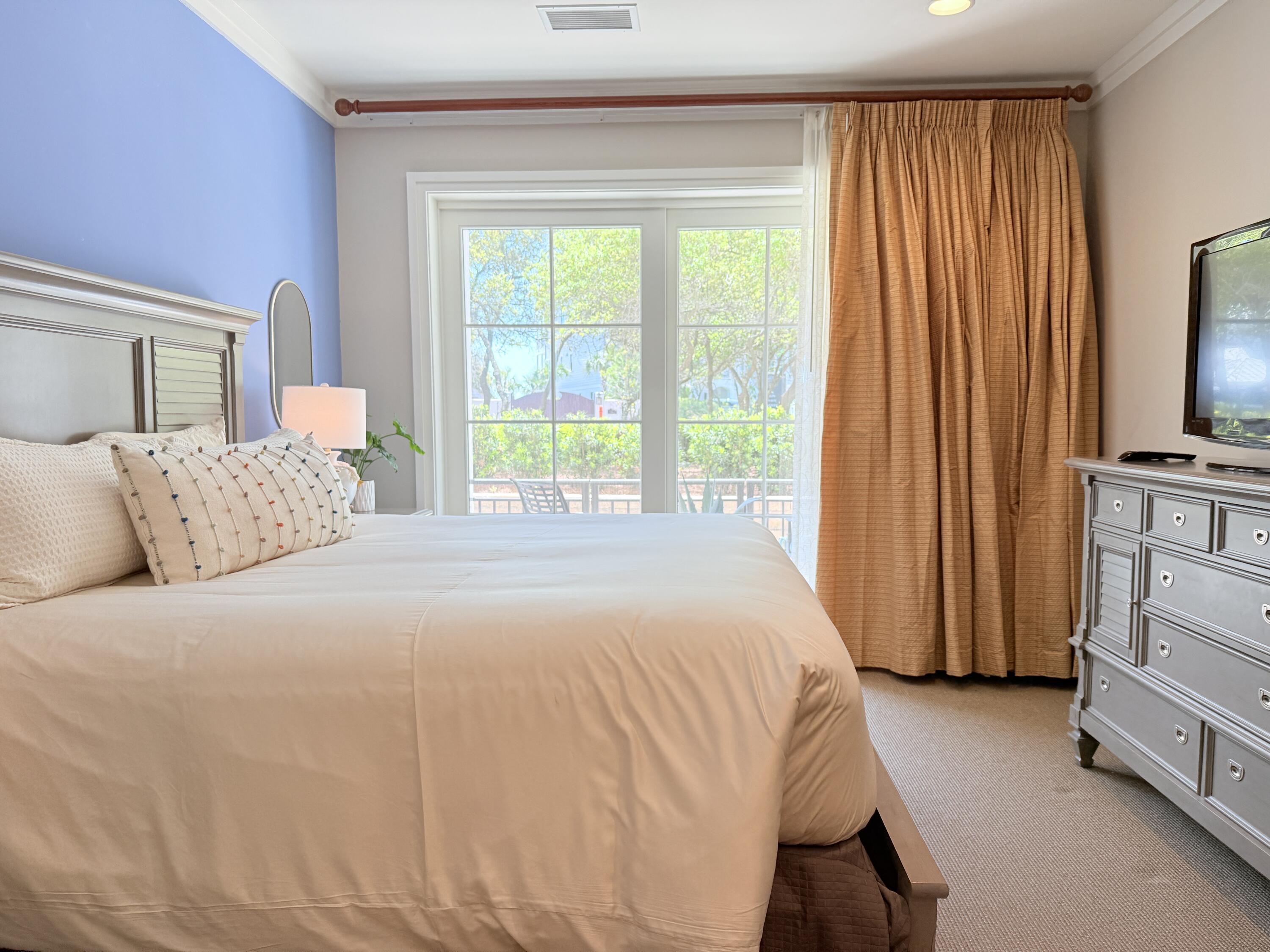 32461 East County Highway 30A, Unit 104 Inlet Beach, FL 32461 - Photo 25 of 97 a bedroom with a bed tv and a window