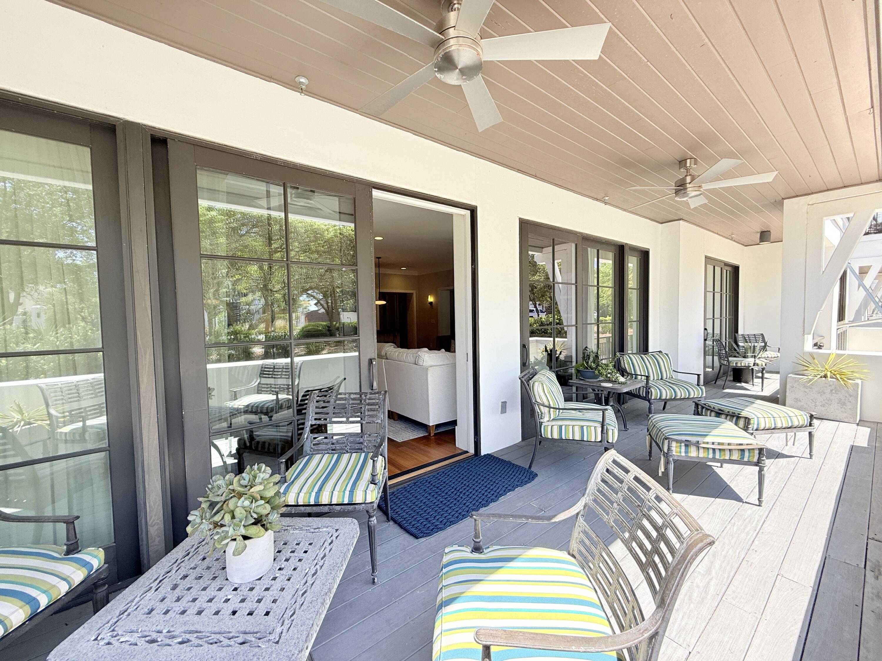 32461 East County Highway 30A, Unit 104 Inlet Beach, FL 32461 - Photo 42 of 97 a living room with furniture floor to ceiling window and wooden floor