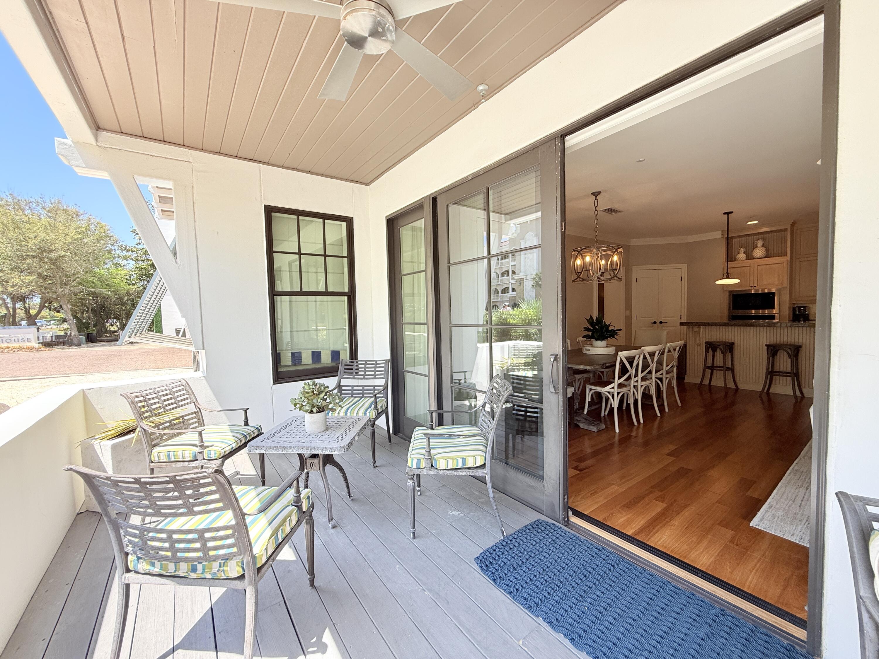 32461 East County Highway 30A, Unit 104 Inlet Beach, FL 32461 - Photo 45 of 97 a dining room with furniture a chandelier and wooden floor