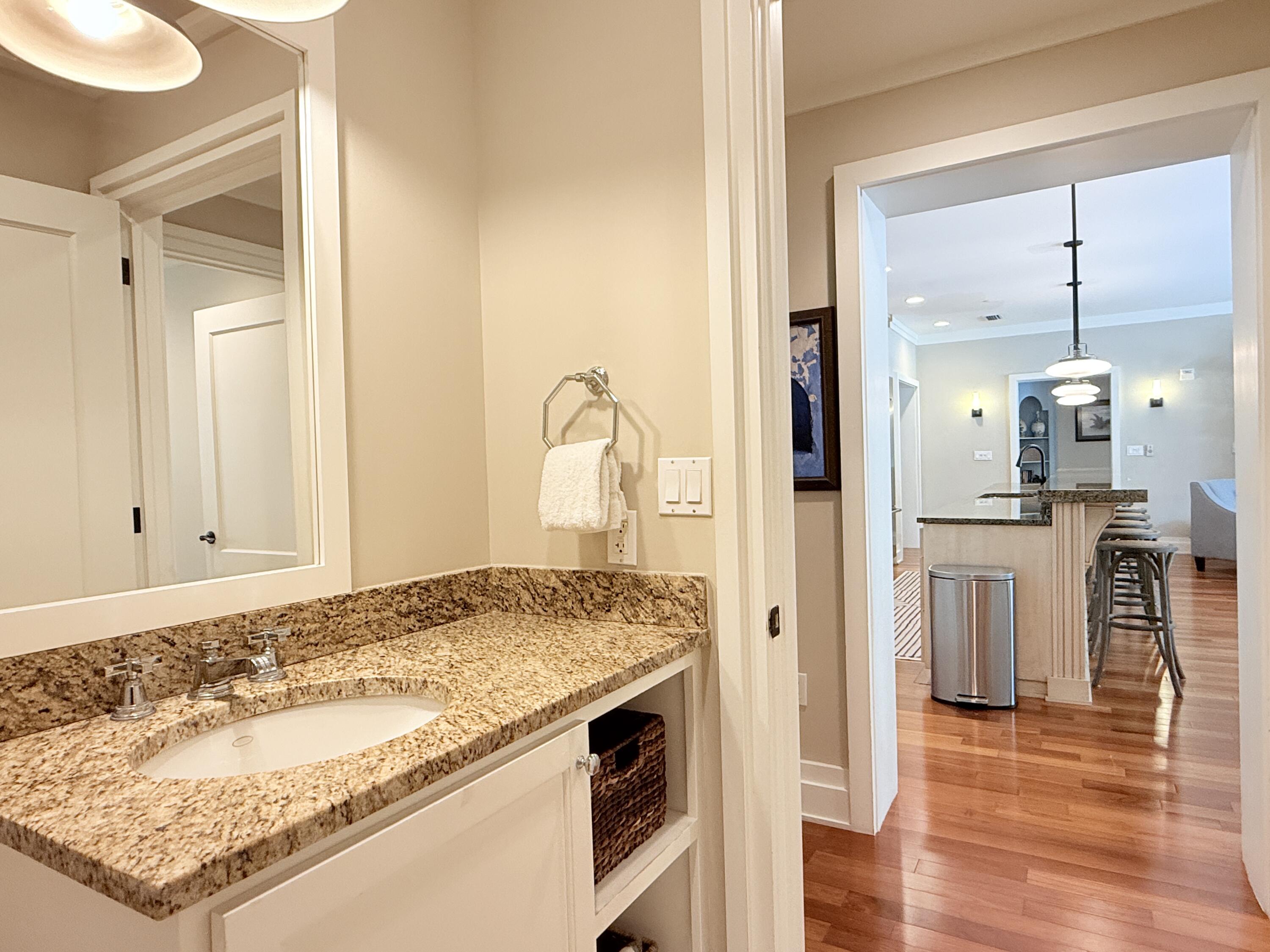 32461 East County Highway 30A, Unit 104 Inlet Beach, FL 32461 - Photo 49 of 97 a bathroom with a granite countertop sink and a mirror