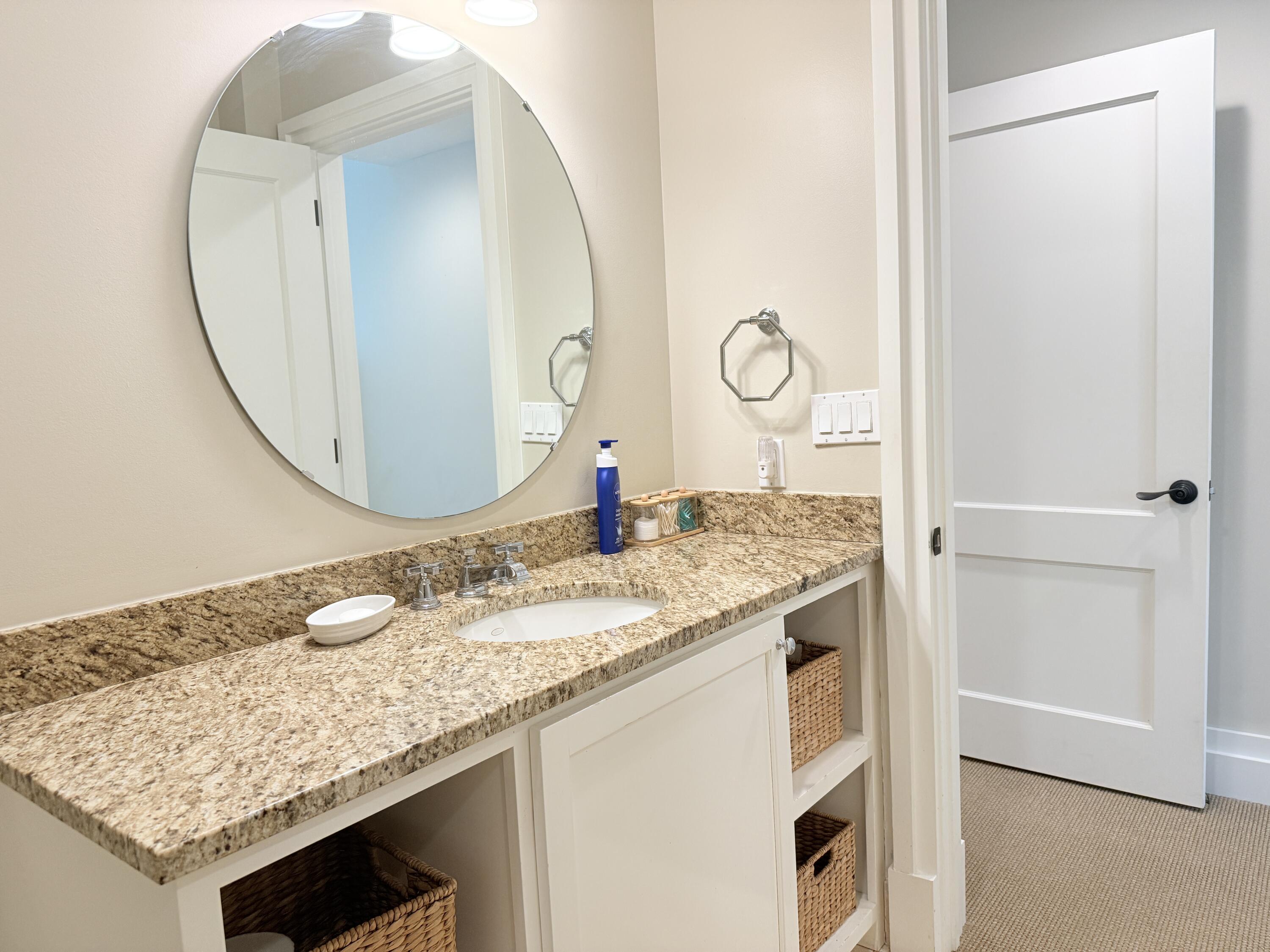32461 East County Highway 30A, Unit 104 Inlet Beach, FL 32461 - Photo 57 of 97 a bathroom with a granite countertop sink and a mirror