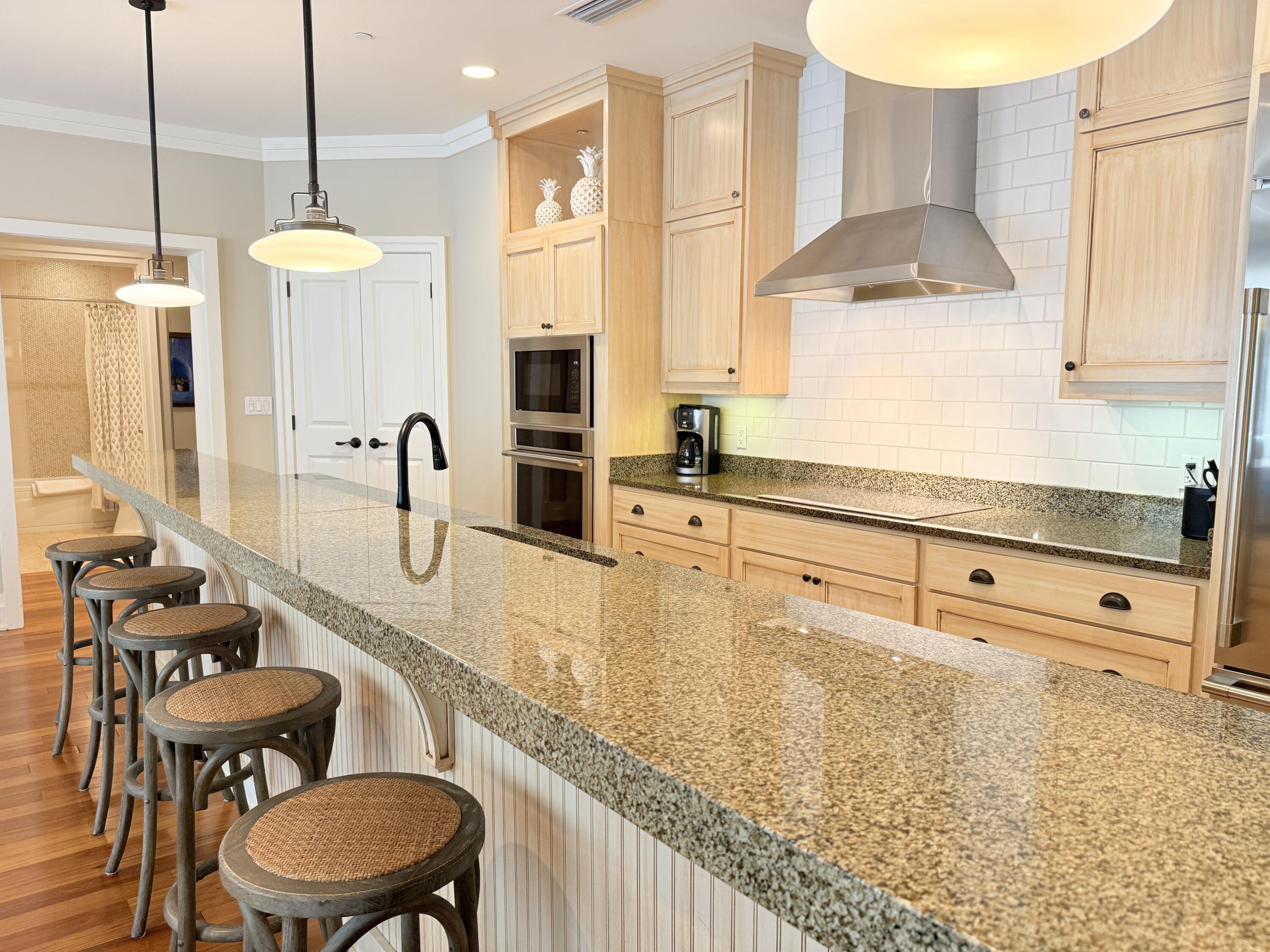 32461 East County Highway 30A, Unit 104 Inlet Beach, FL 32461 - Photo 8 of 97 a kitchen with stainless steel appliances a sink a stove and a wooden floor