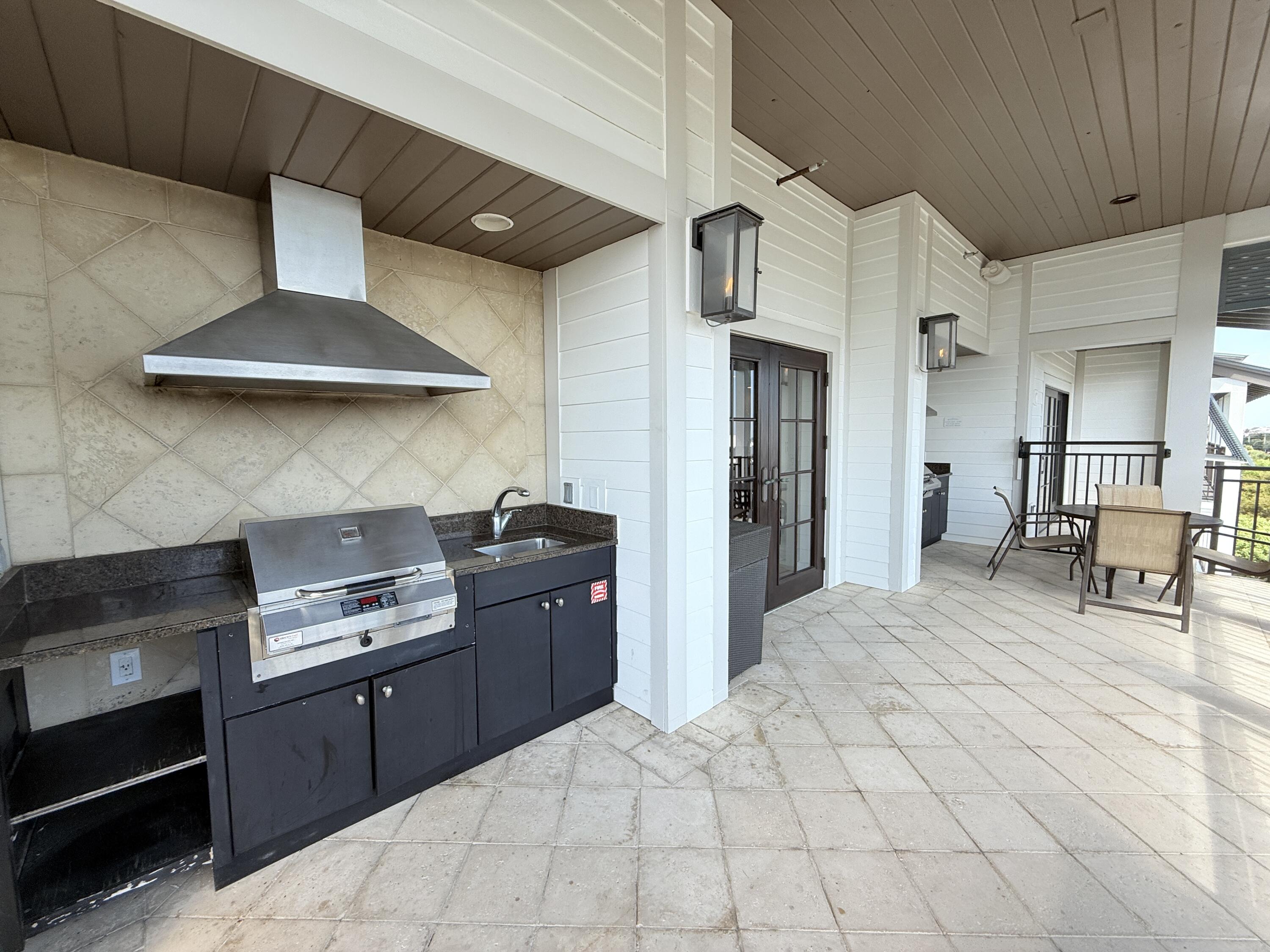 32461 East County Highway 30A, Unit 104 Inlet Beach, FL 32461 - Photo 84 of 97 a kitchen with stainless steel appliances kitchen island granite countertop a stove a sink and a refrigerator