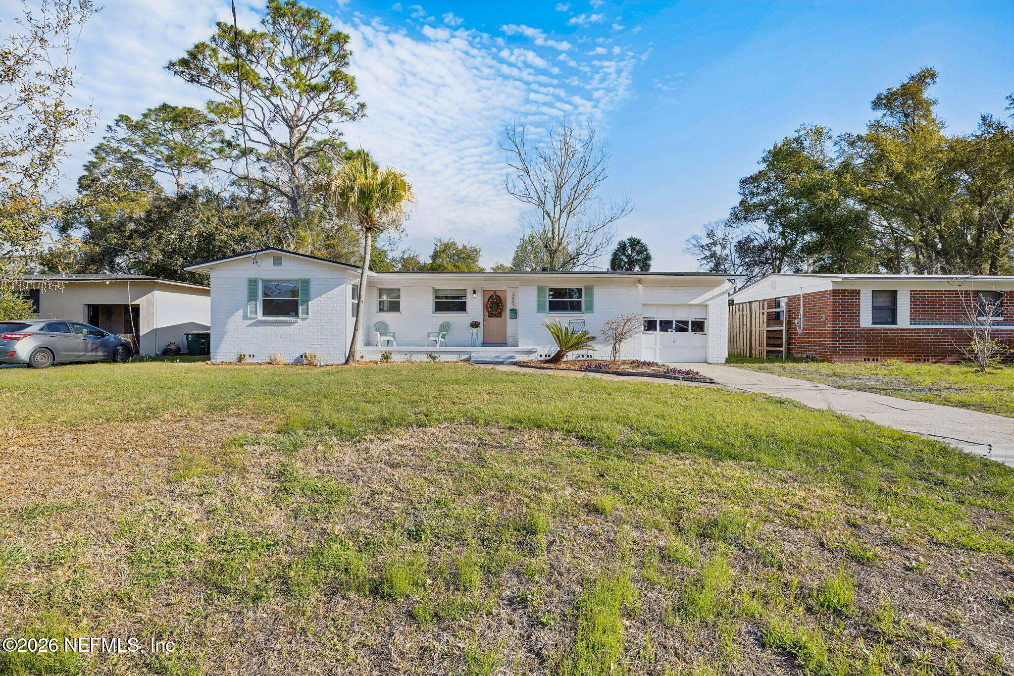 3647 Coronado Road Jacksonville, FL 32217 - Photo 1 of 49 a front view of a house with a yard table and chairs