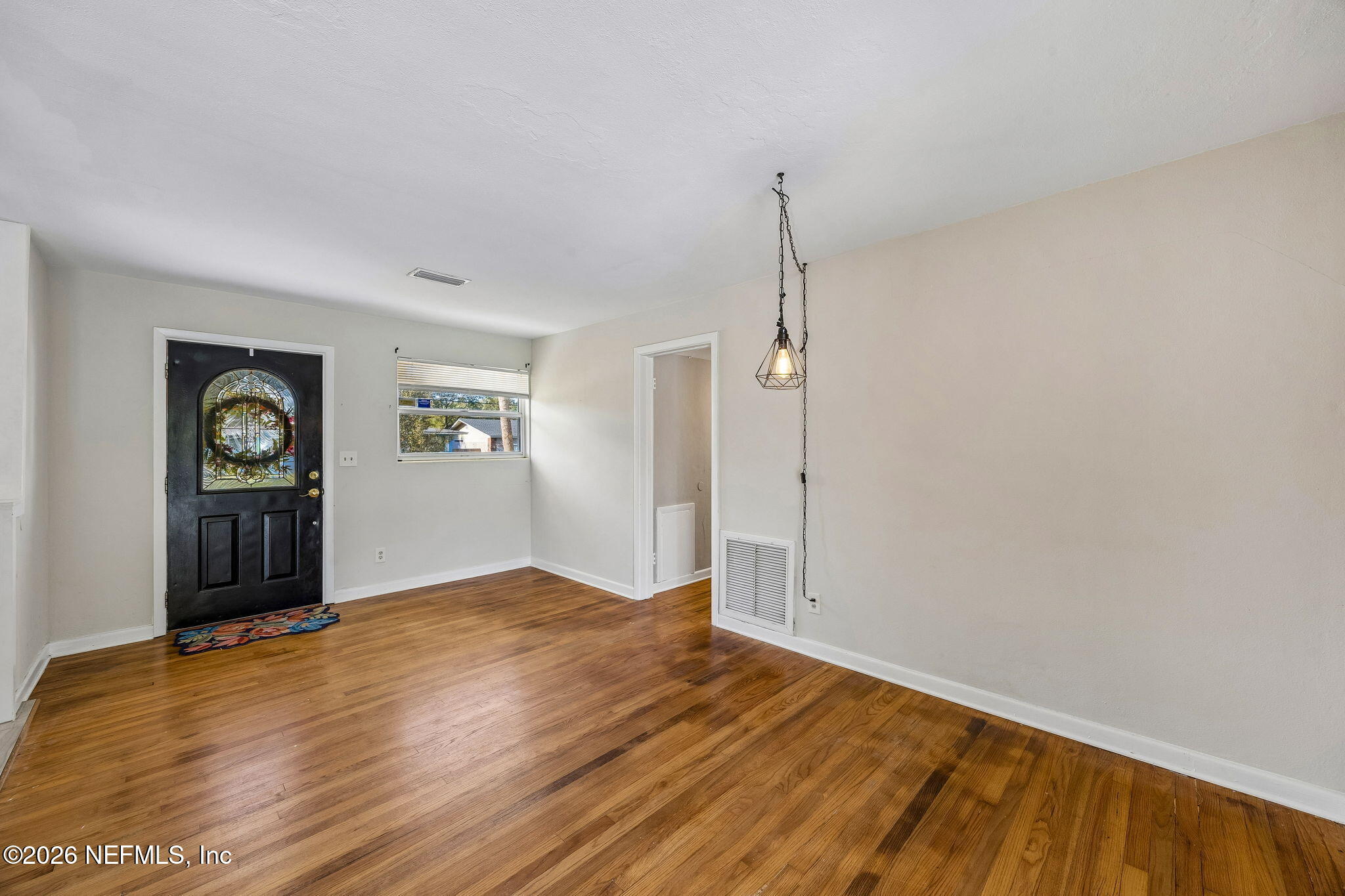 3647 Coronado Road Jacksonville, FL 32217 - Photo 11 of 49 a view of empty room with window and wooden floor