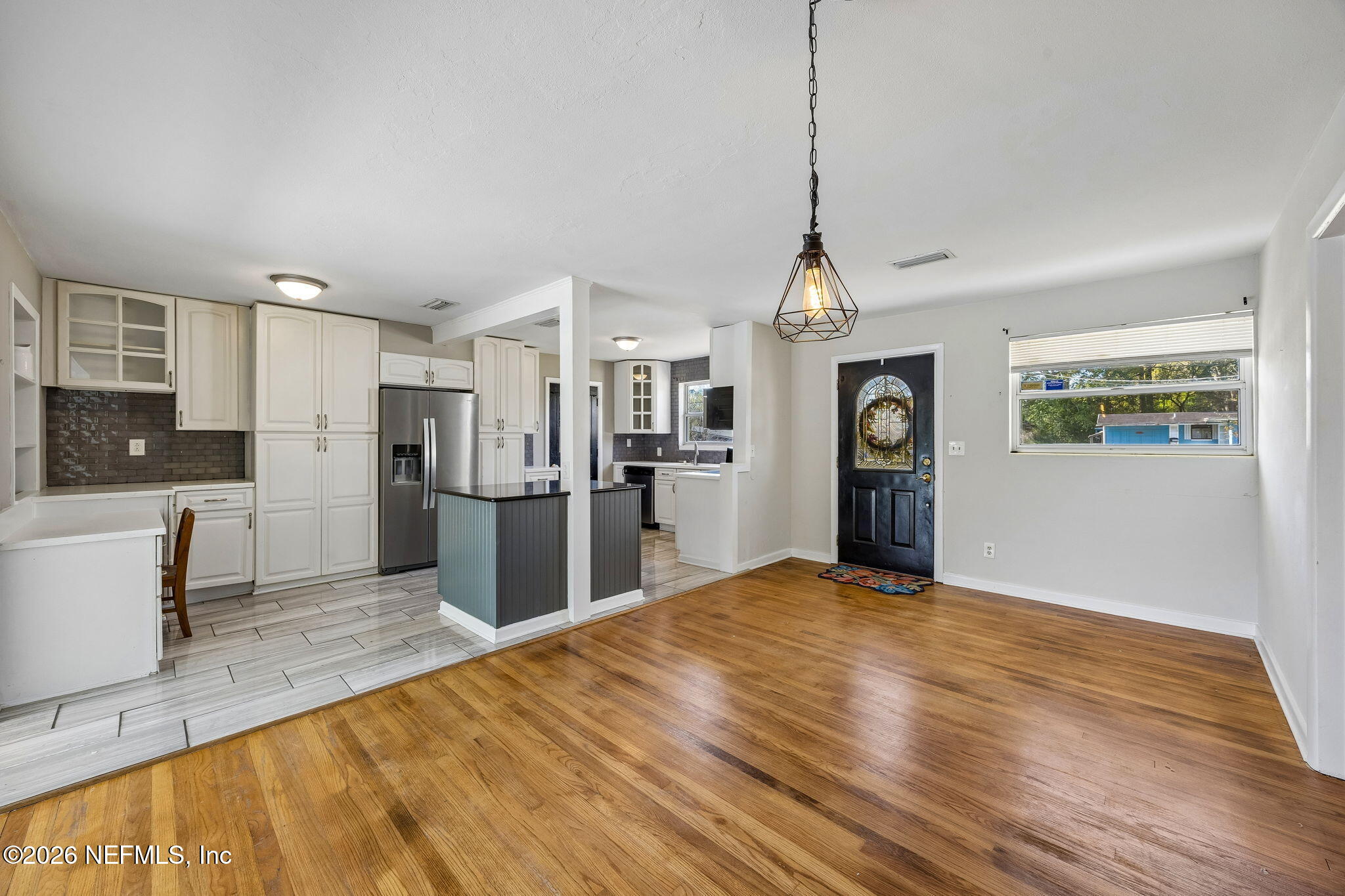 3647 Coronado Road Jacksonville, FL 32217 - Photo 12 of 49 a view of a kitchen with refrigerator stove and wooden floor