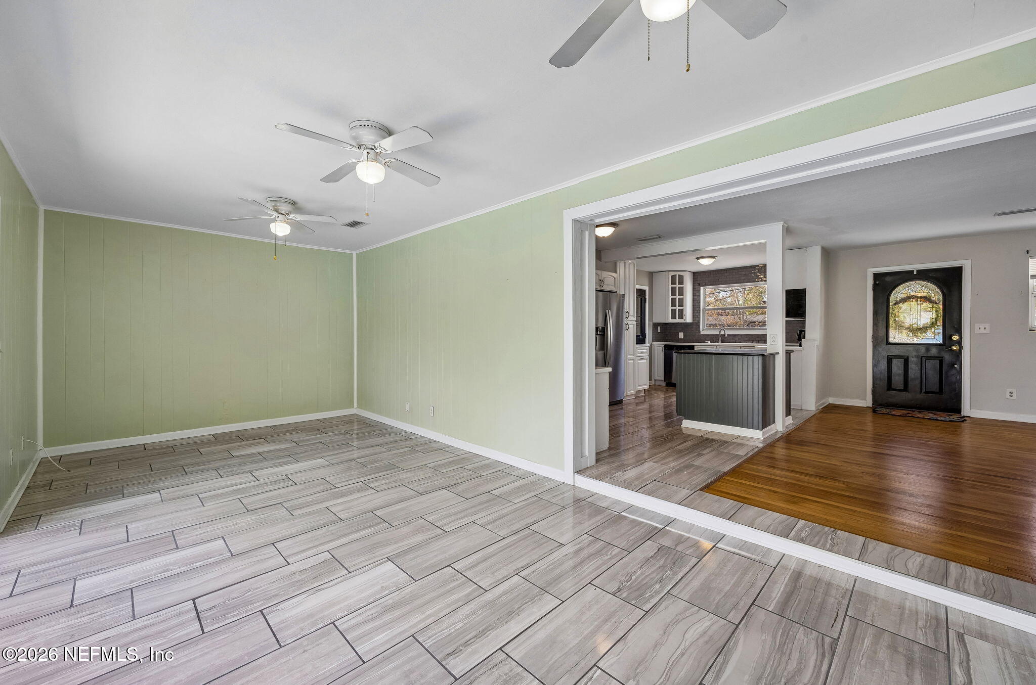 3647 Coronado Road Jacksonville, FL 32217 - Photo 14 of 49 a view of an empty room and window with wooden floor