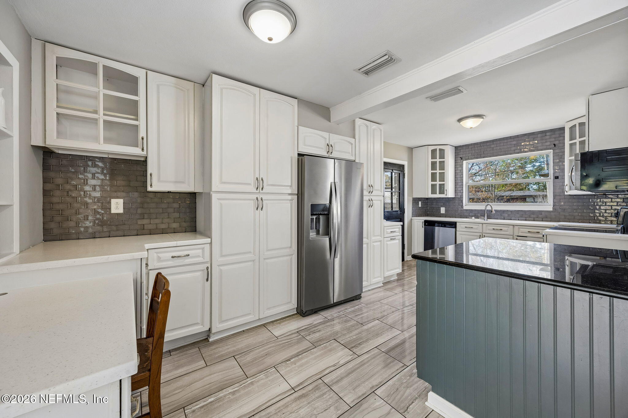 3647 Coronado Road Jacksonville, FL 32217 - Photo 17 of 49 a kitchen with stainless steel appliances granite countertop a refrigerator a stove a sink a microwave and island