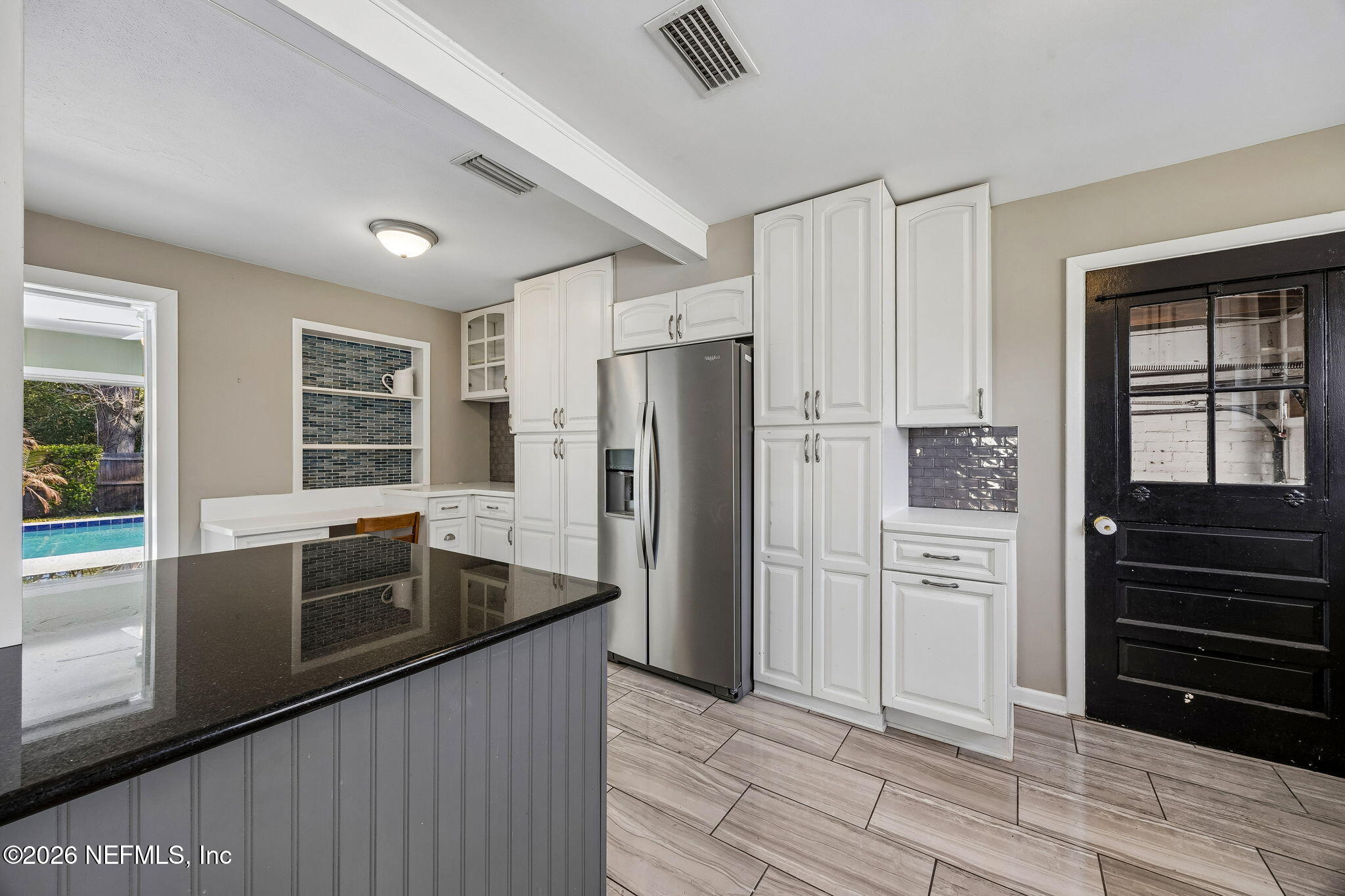 3647 Coronado Road Jacksonville, FL 32217 - Photo 18 of 49 a kitchen with stainless steel appliances granite countertop a refrigerator and a sink
