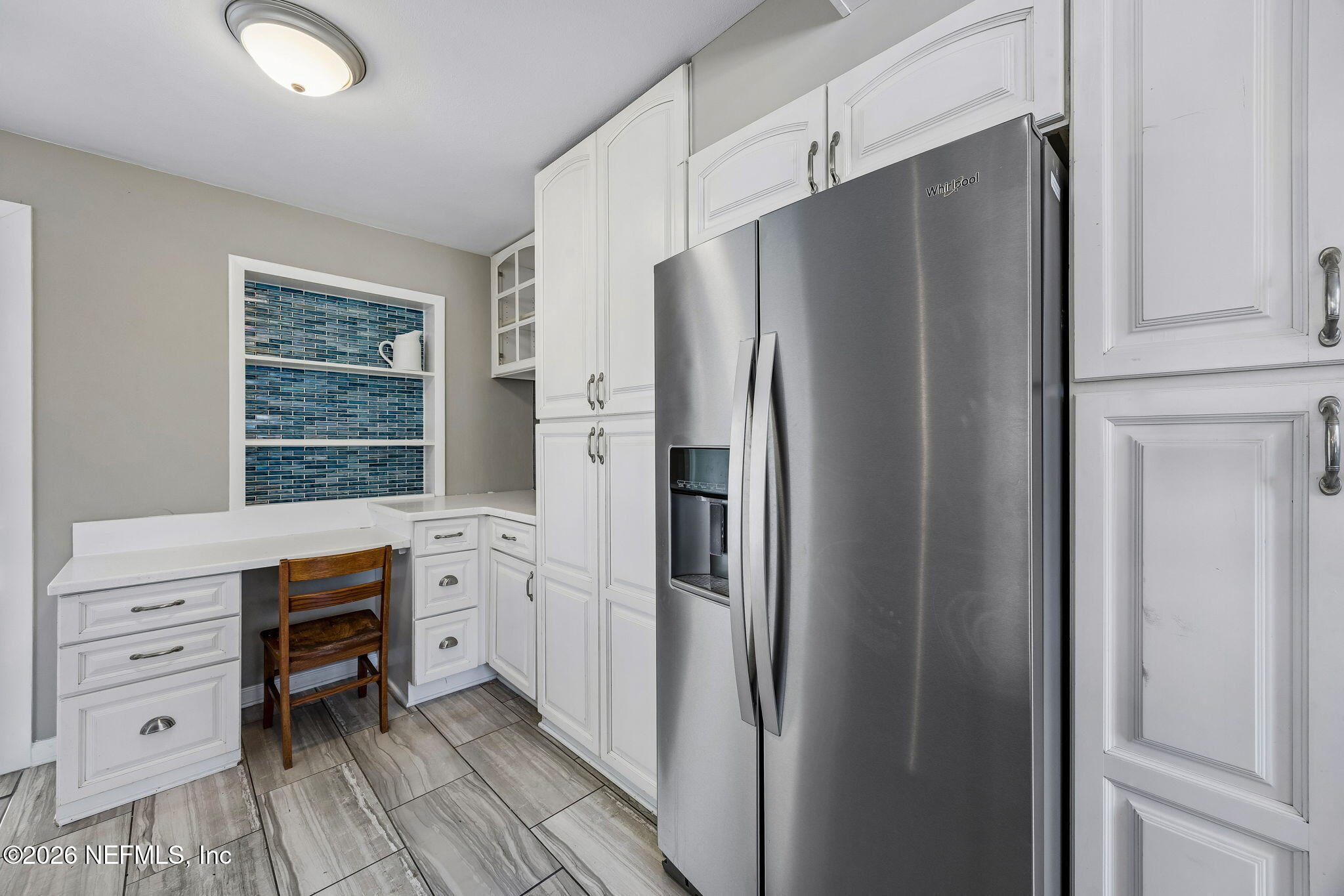 3647 Coronado Road Jacksonville, FL 32217 - Photo 22 of 49 a kitchen with white cabinets and refrigerator