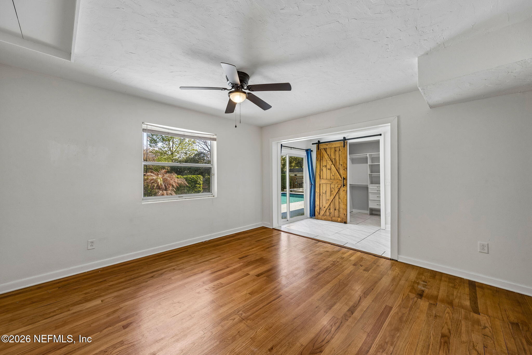 3647 Coronado Road Jacksonville, FL 32217 - Photo 24 of 49 a view of an empty room with window and wooden floor