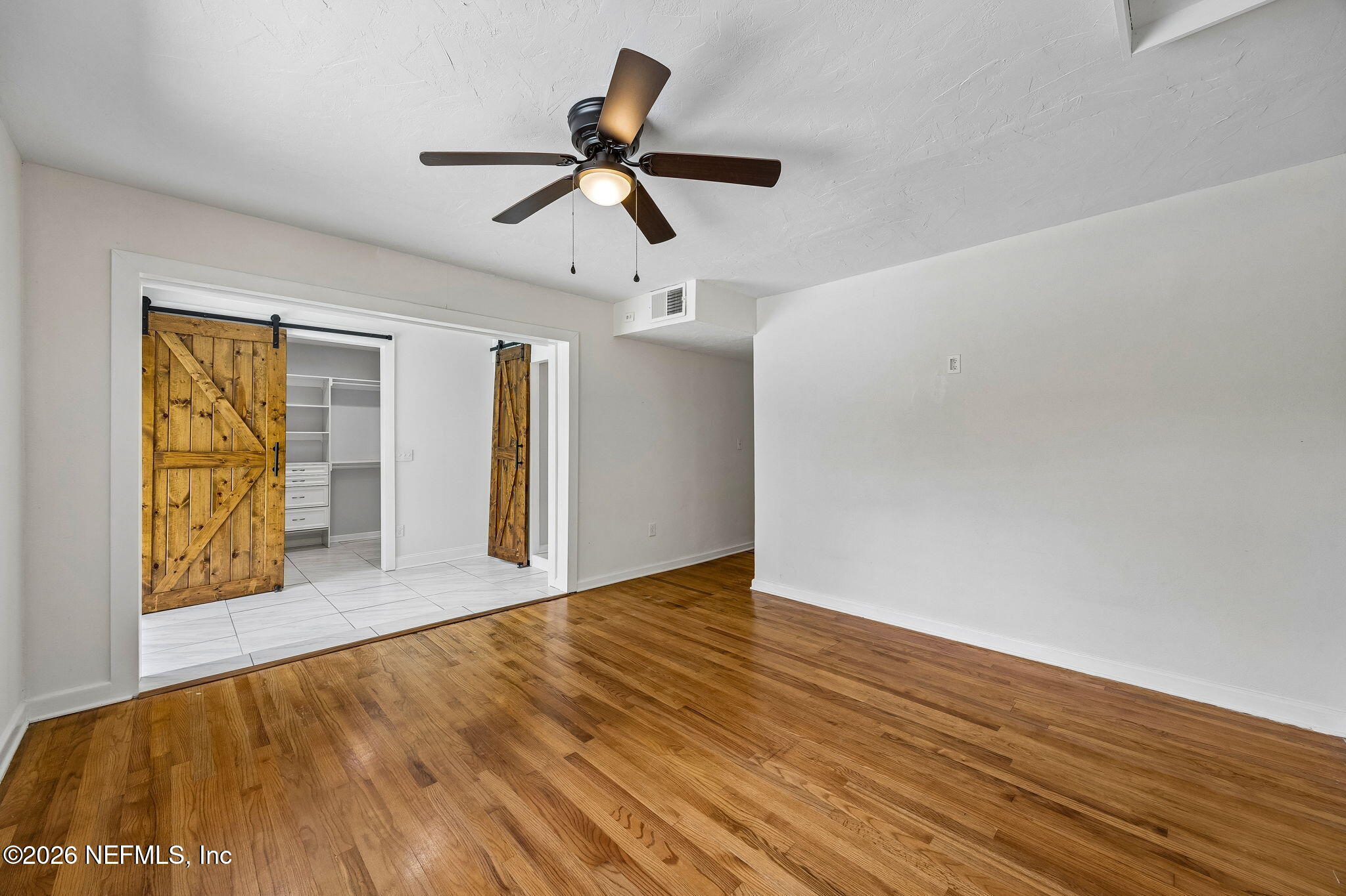 3647 Coronado Road Jacksonville, FL 32217 - Photo 25 of 49 a view of empty room with wooden floor and fan