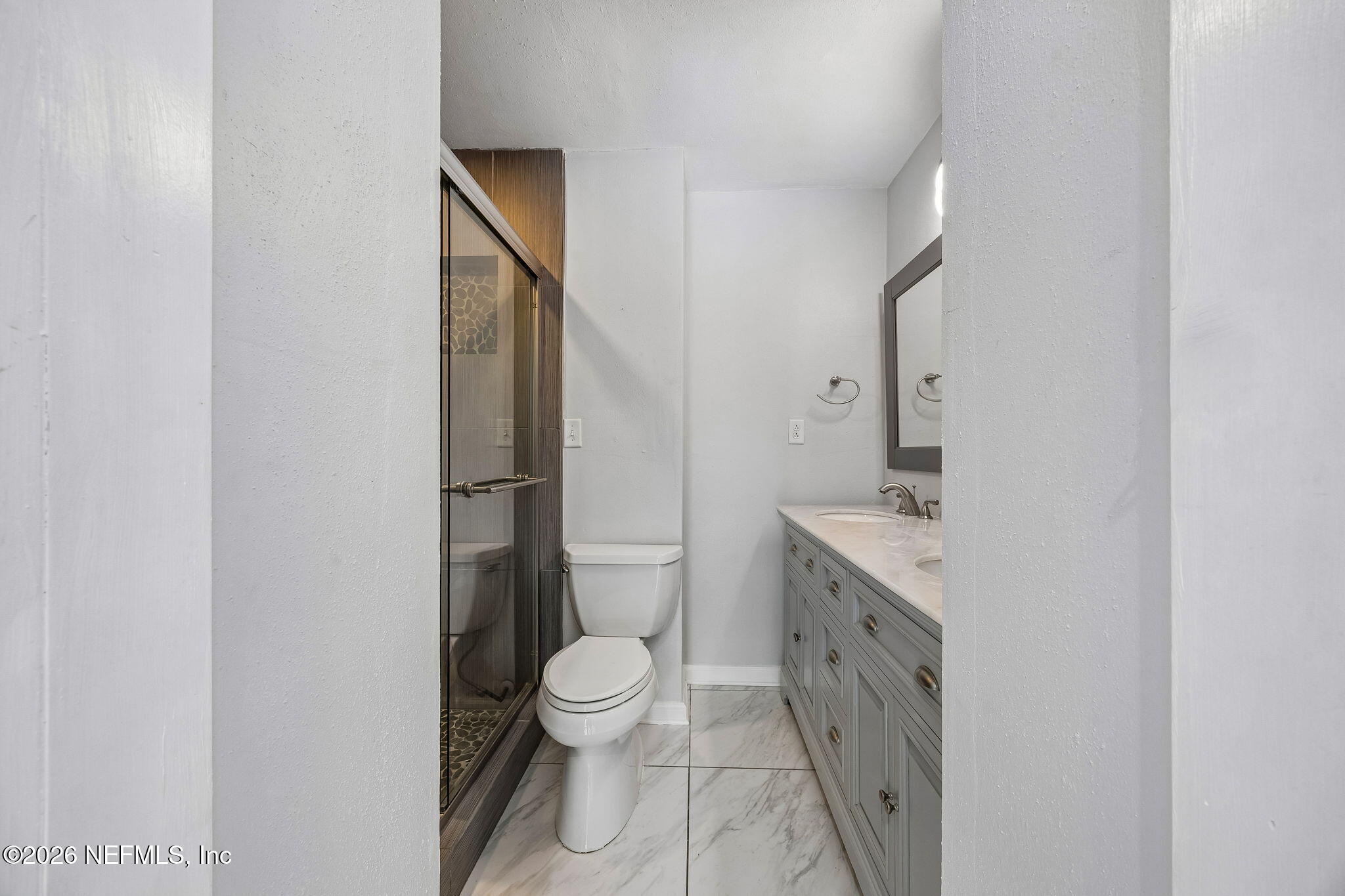 3647 Coronado Road Jacksonville, FL 32217 - Photo 28 of 49 a bathroom with a granite countertop toilet sink and mirror