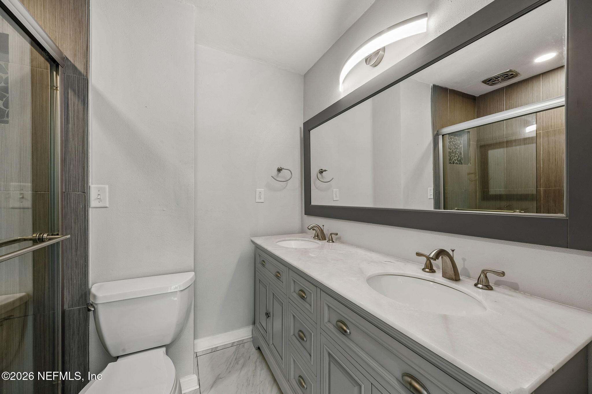 3647 Coronado Road Jacksonville, FL 32217 - Photo 29 of 49 a bathroom with a granite countertop sink mirror vanity and toilet
