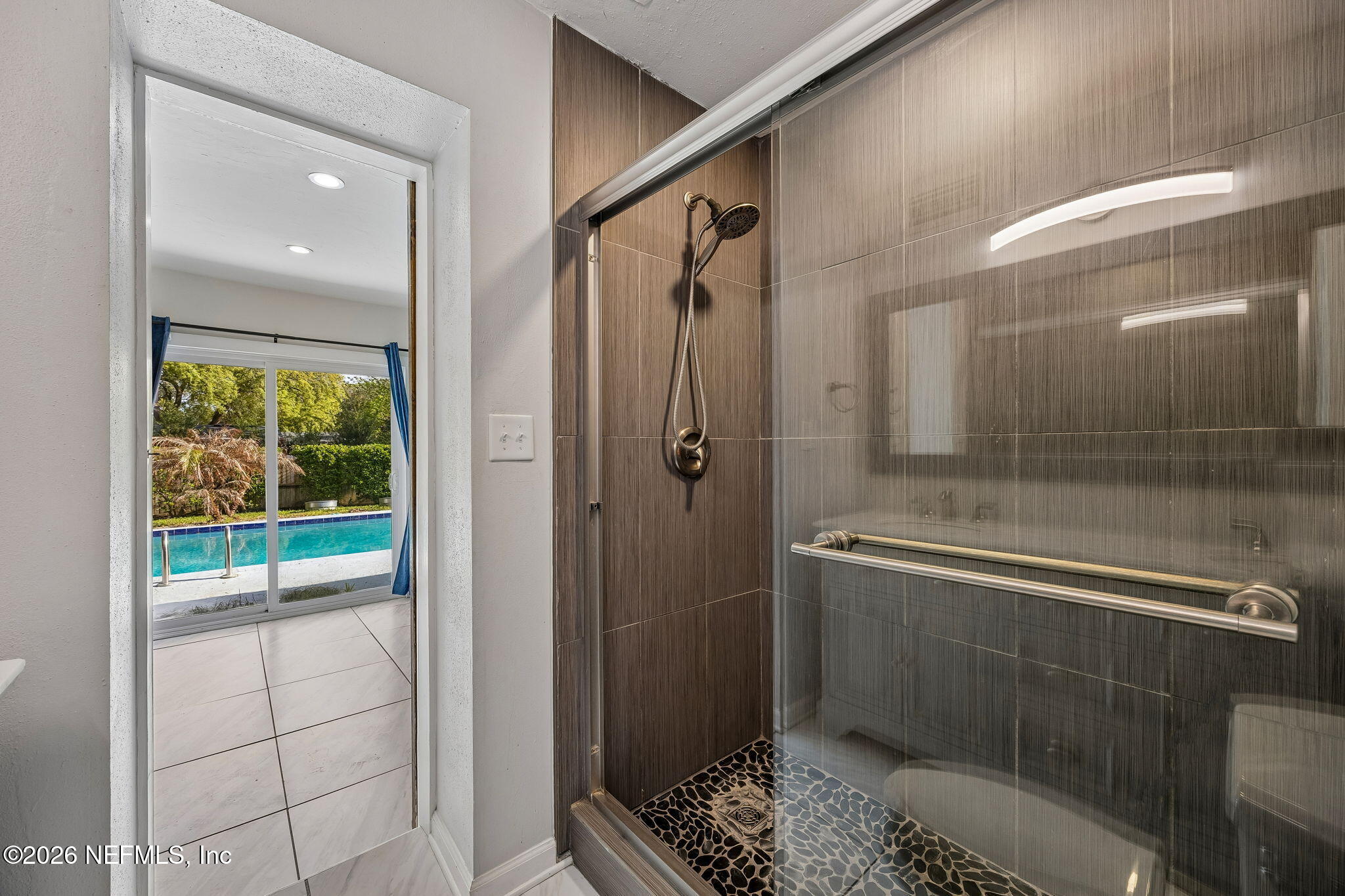 3647 Coronado Road Jacksonville, FL 32217 - Photo 30 of 49 a bathroom with a glass shower door