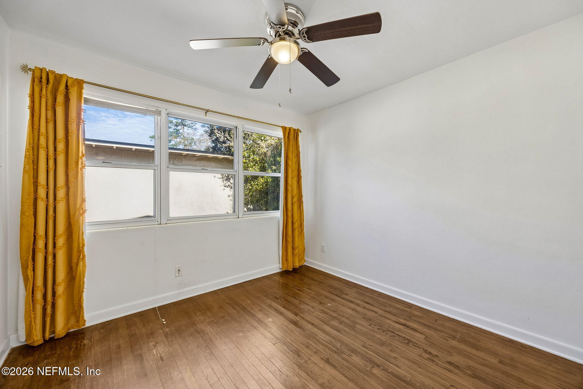 3647 Coronado Road Jacksonville, FL 32217 - Photo 32 of 49 wooden floor in an empty room with a window