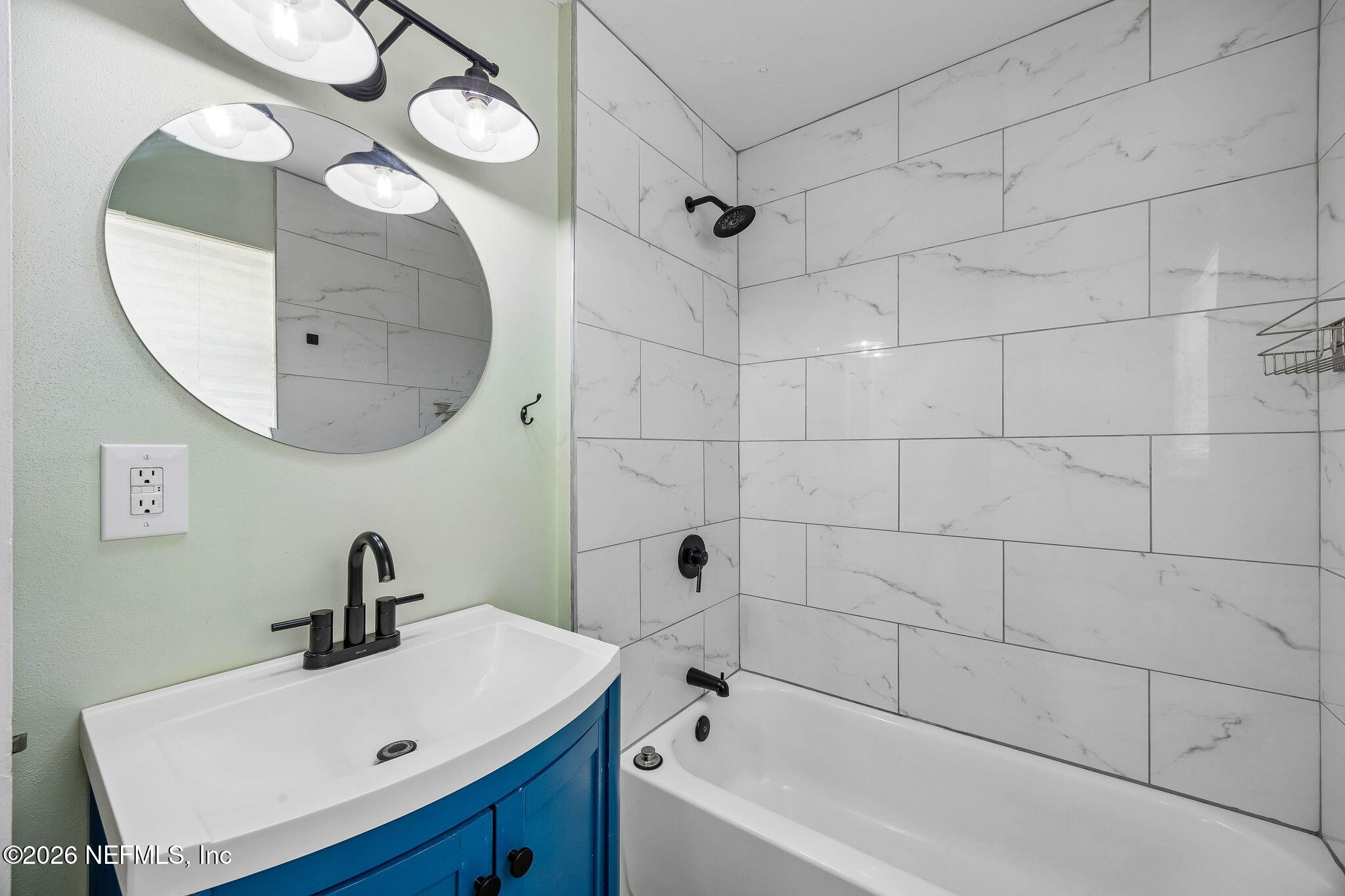 3647 Coronado Road Jacksonville, FL 32217 - Photo 35 of 49 a bathroom with a sink mirror and vanity