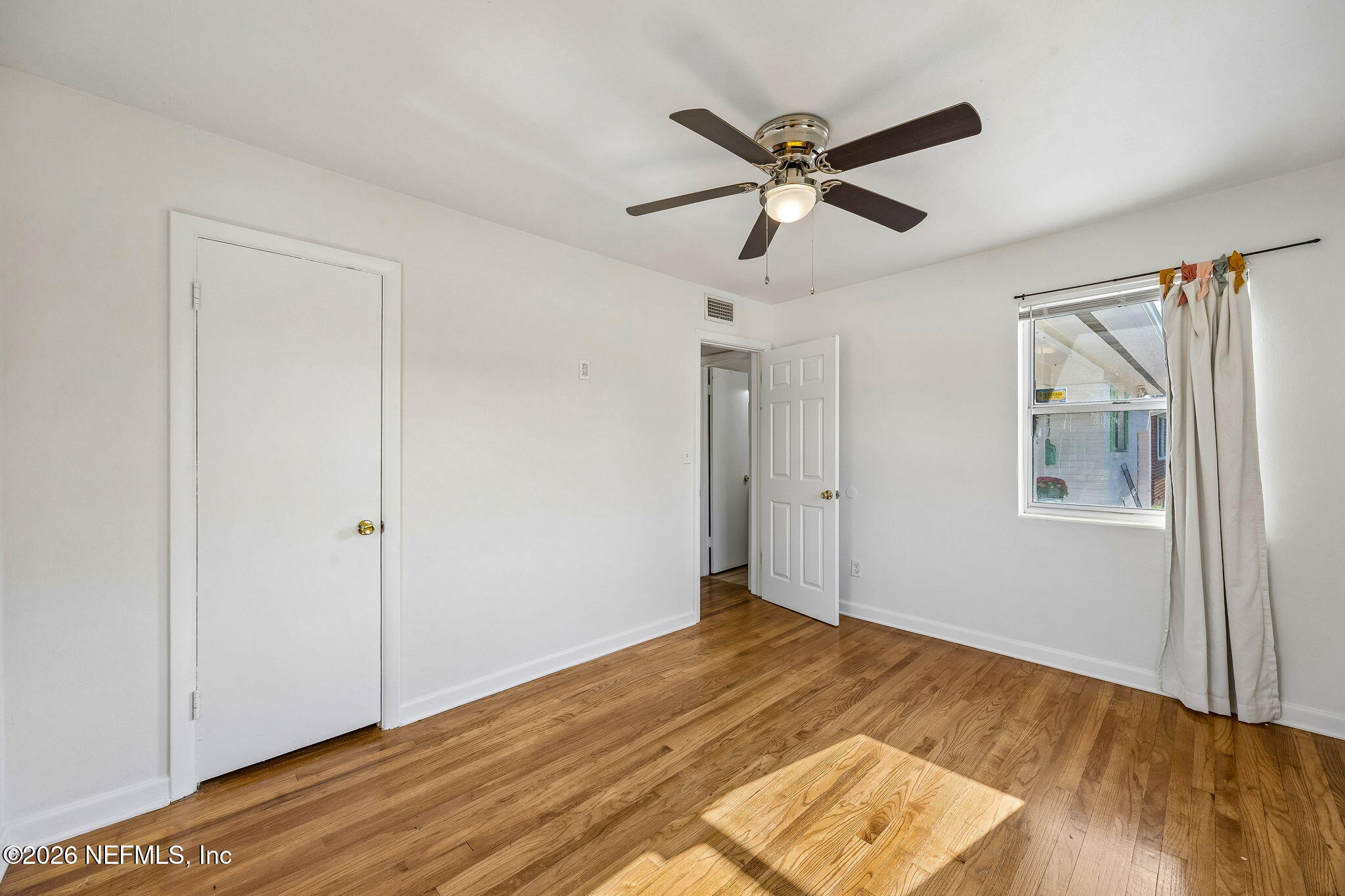 3647 Coronado Road Jacksonville, FL 32217 - Photo 37 of 49 a view of a livingroom with a ceiling fan and wooden floor