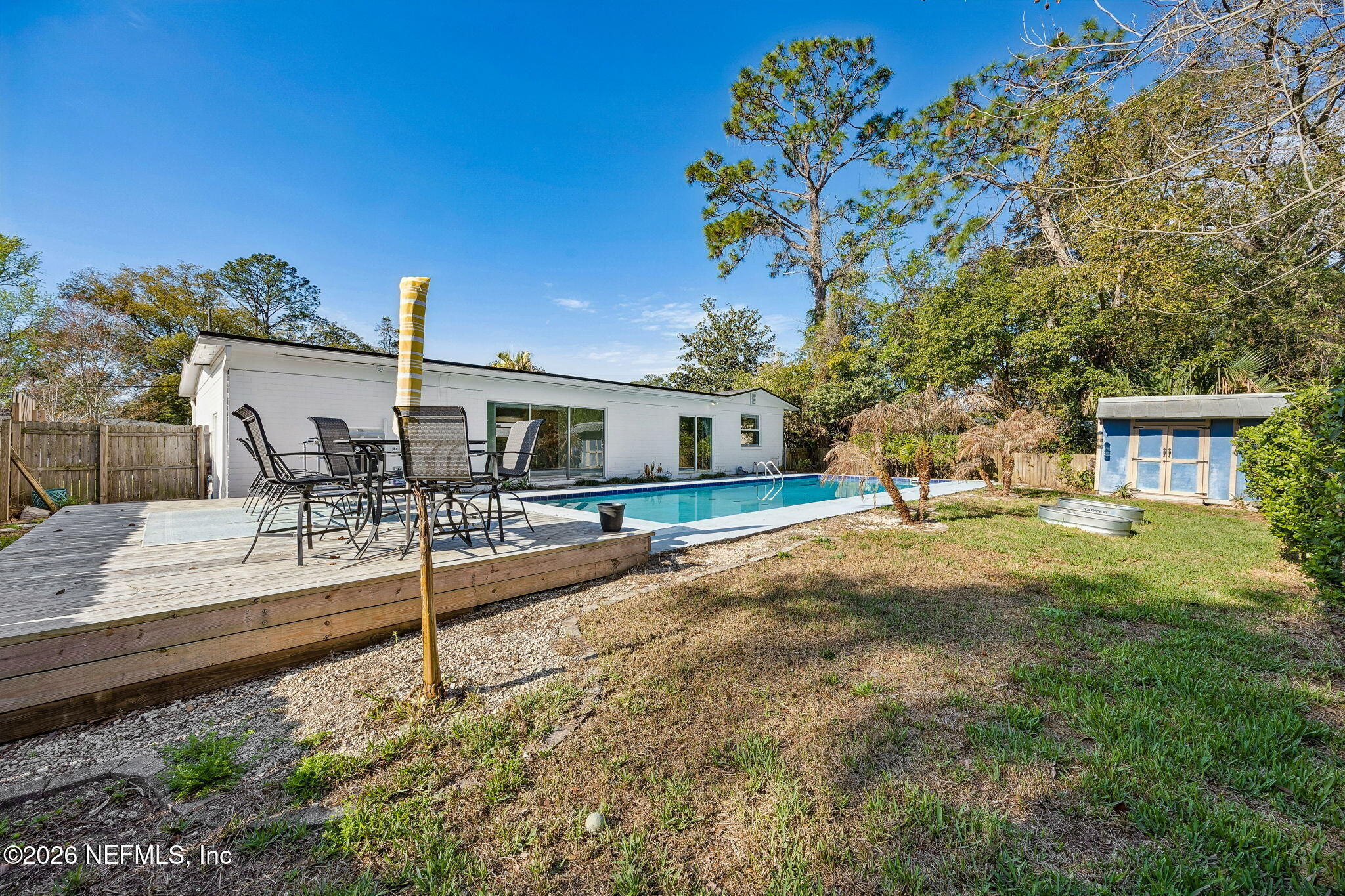 3647 Coronado Road Jacksonville, FL 32217 - Photo 43 of 49 a backyard of a house with table and chairs