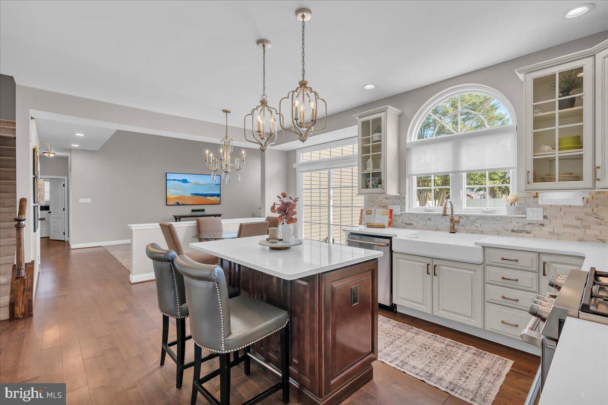 8 Elk Court Sewell, NJ 08080 - Photo 11 of 38 a dining room with wooden floor a chandelier a wooden table and chairs