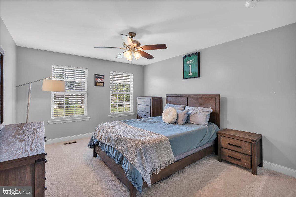 8 Elk Court Sewell, NJ 08080 - Photo 17 of 38 a bedroom with a bed chandelier and a window