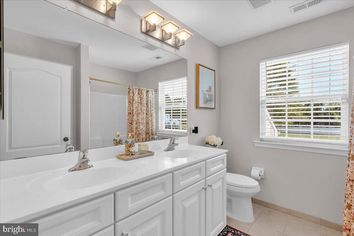 8 Elk Court Sewell, NJ 08080 - Photo 18 of 38 a bathroom with double vanity sink a toilet and a window