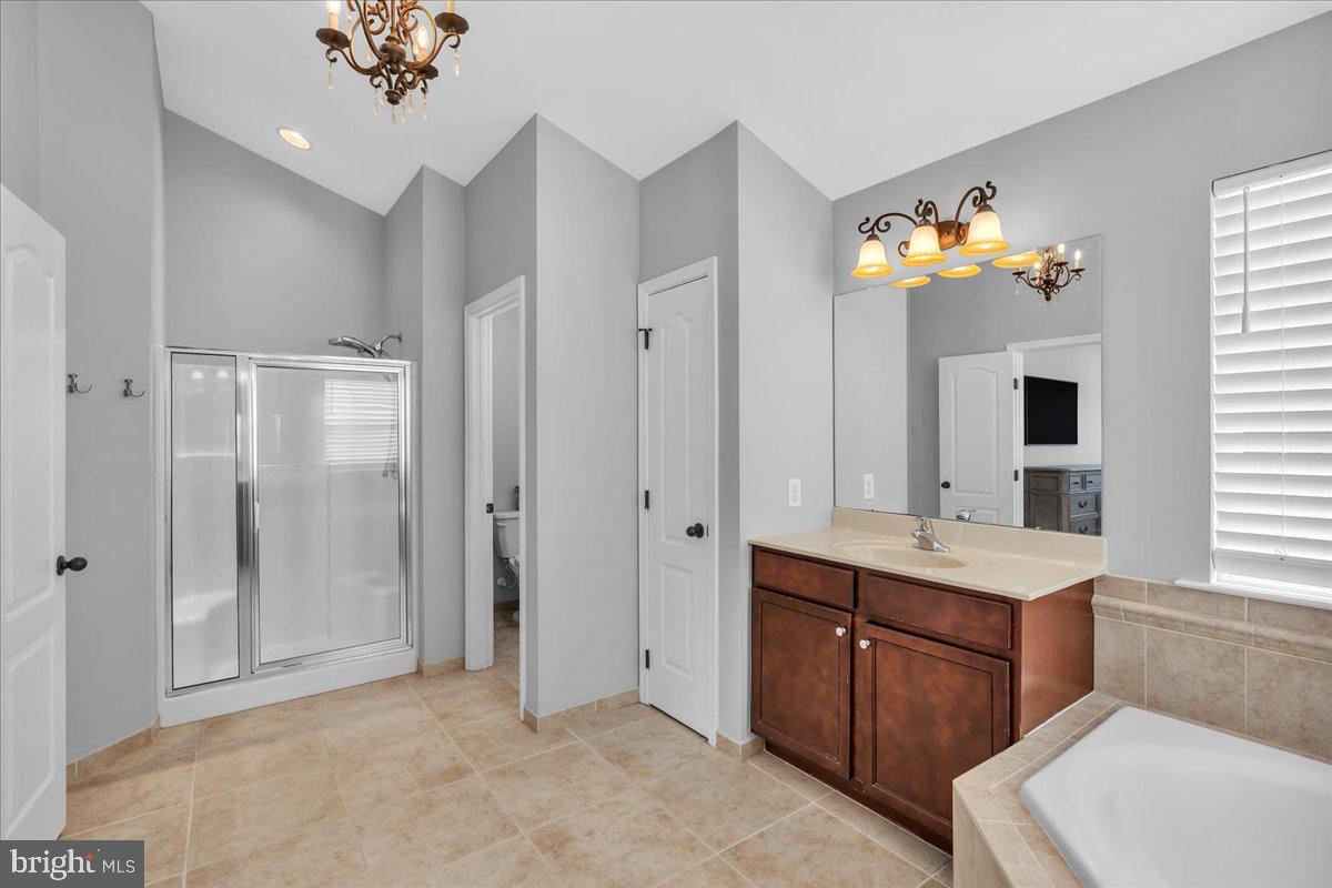8 Elk Court Sewell, NJ 08080 - Photo 23 of 38 a spacious bathroom with a granite countertop sink a toilet a mirror and window