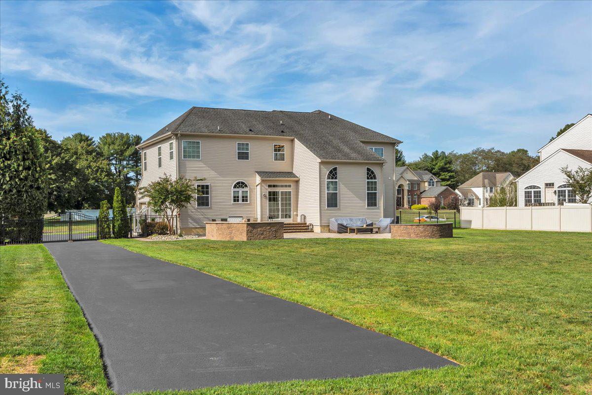 8 Elk Court Sewell, NJ 08080 - Photo 30 of 38 a view of a white house in front of a big yard with plants and large trees