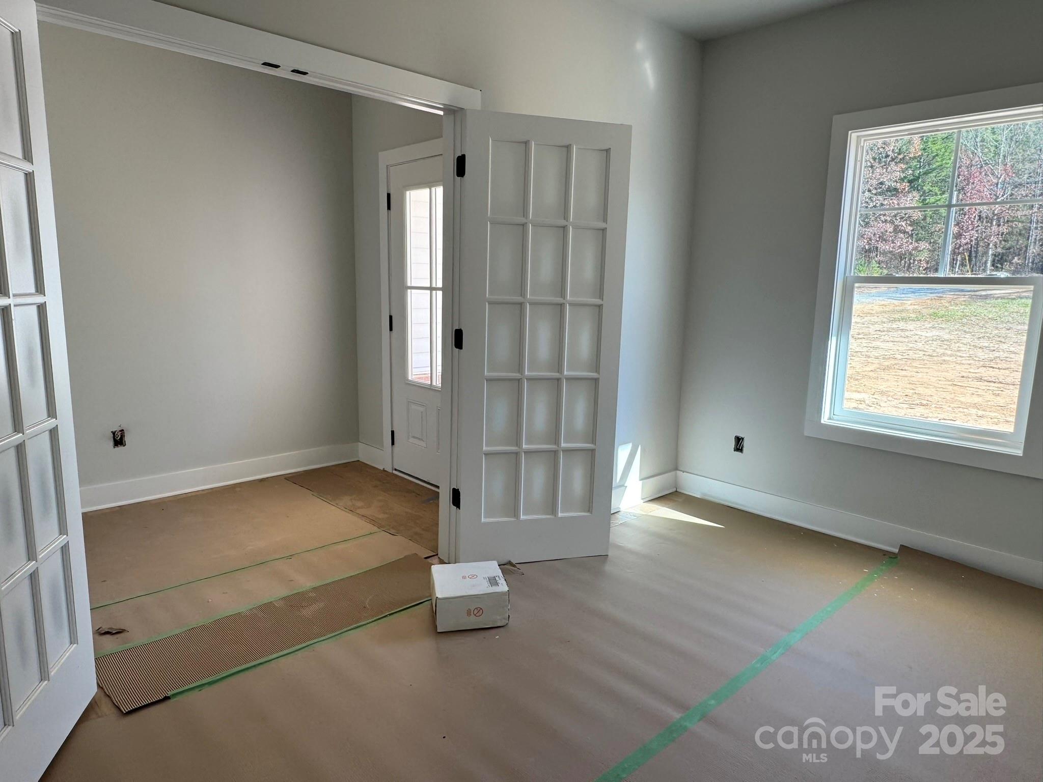 6229 King Wilkinson Road Denver, NC 28037 - Photo 2 of 14 a view of an empty room with wooden floor and a window