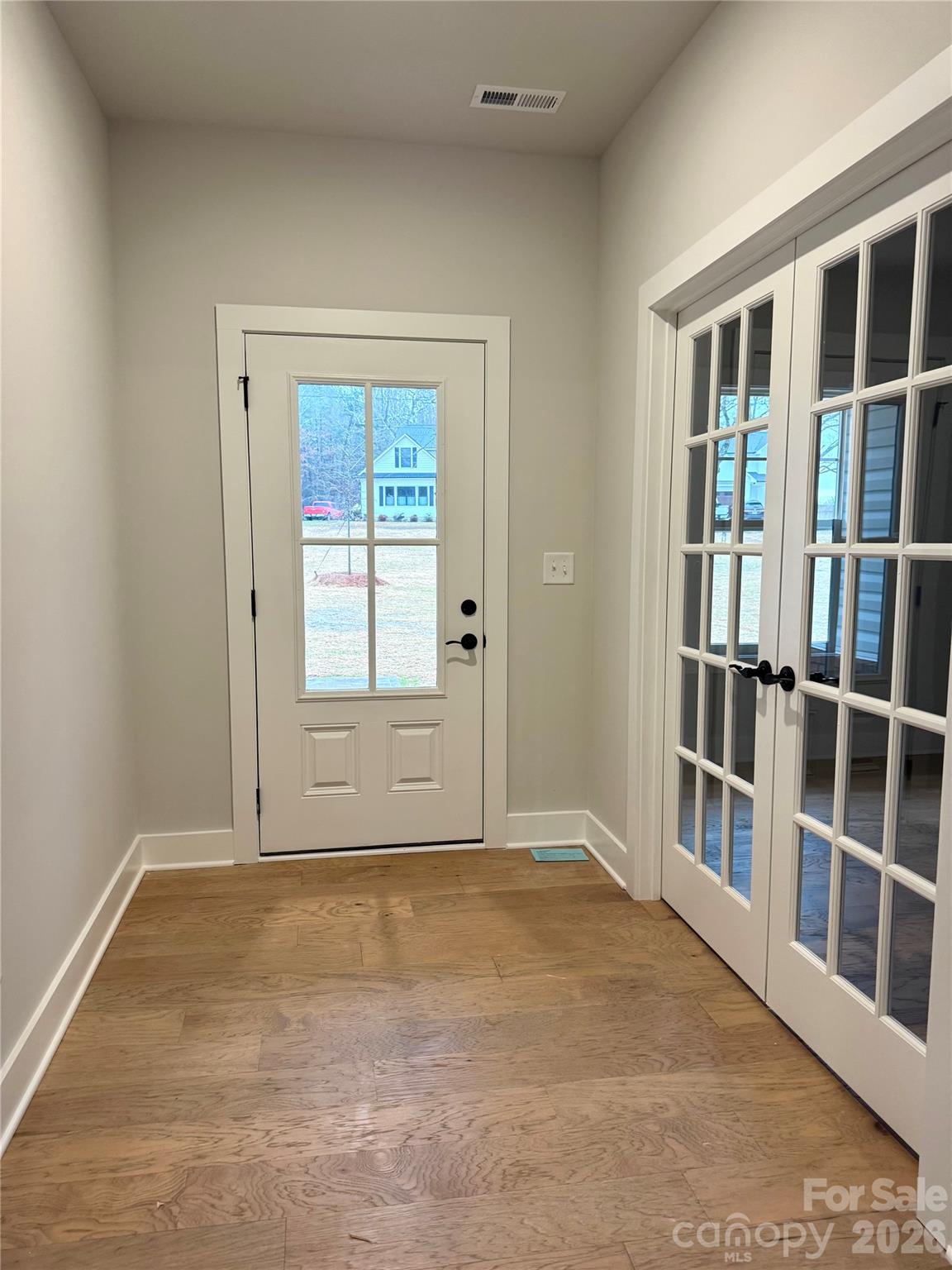 6229 King Wilkinson Road Denver, NC 28037 - Photo 2 of 13 a view of an empty room with white walls and windows