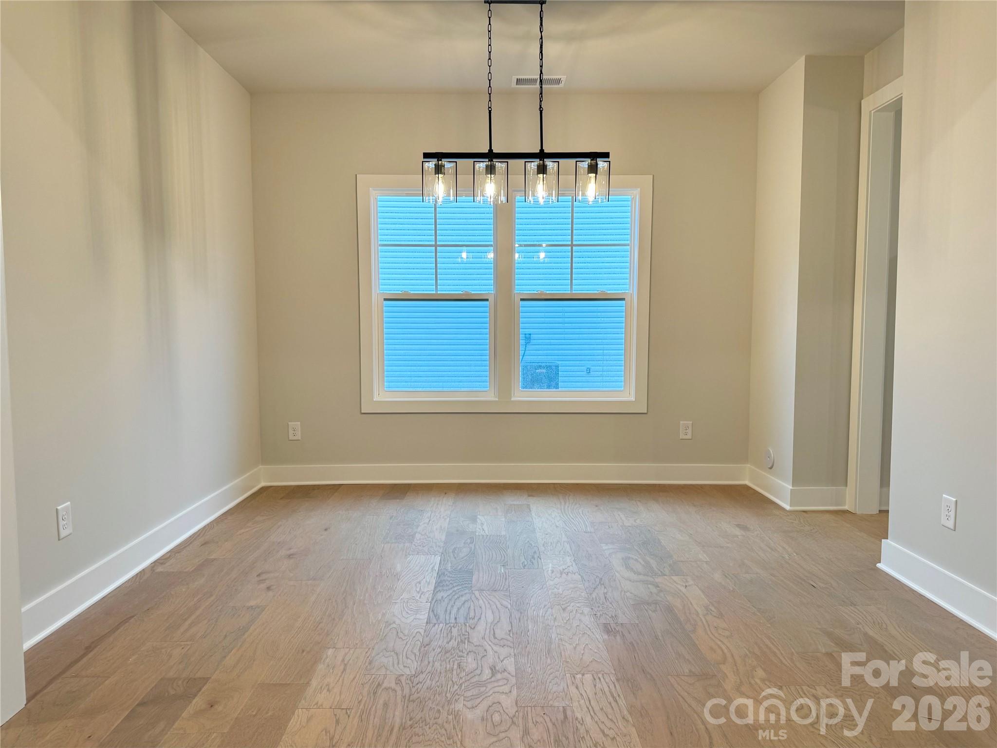 6229 King Wilkinson Road Denver, NC 28037 - Photo 5 of 13 a view of an empty room with window and wooden floor