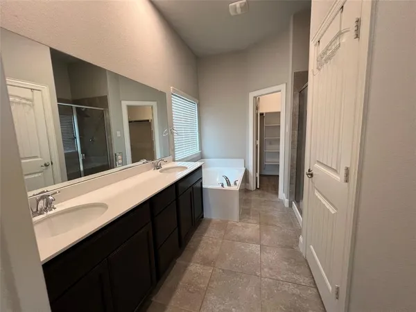 a kitchen with a sink a microwave and a refrigerator