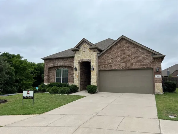 a front view of house with a garden