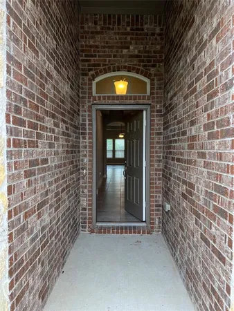 a view of a wooden door with brick wall