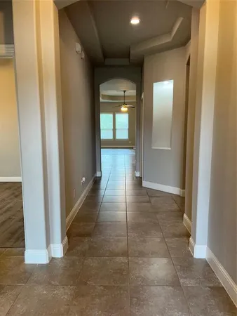 a view of hallway with wooden floor